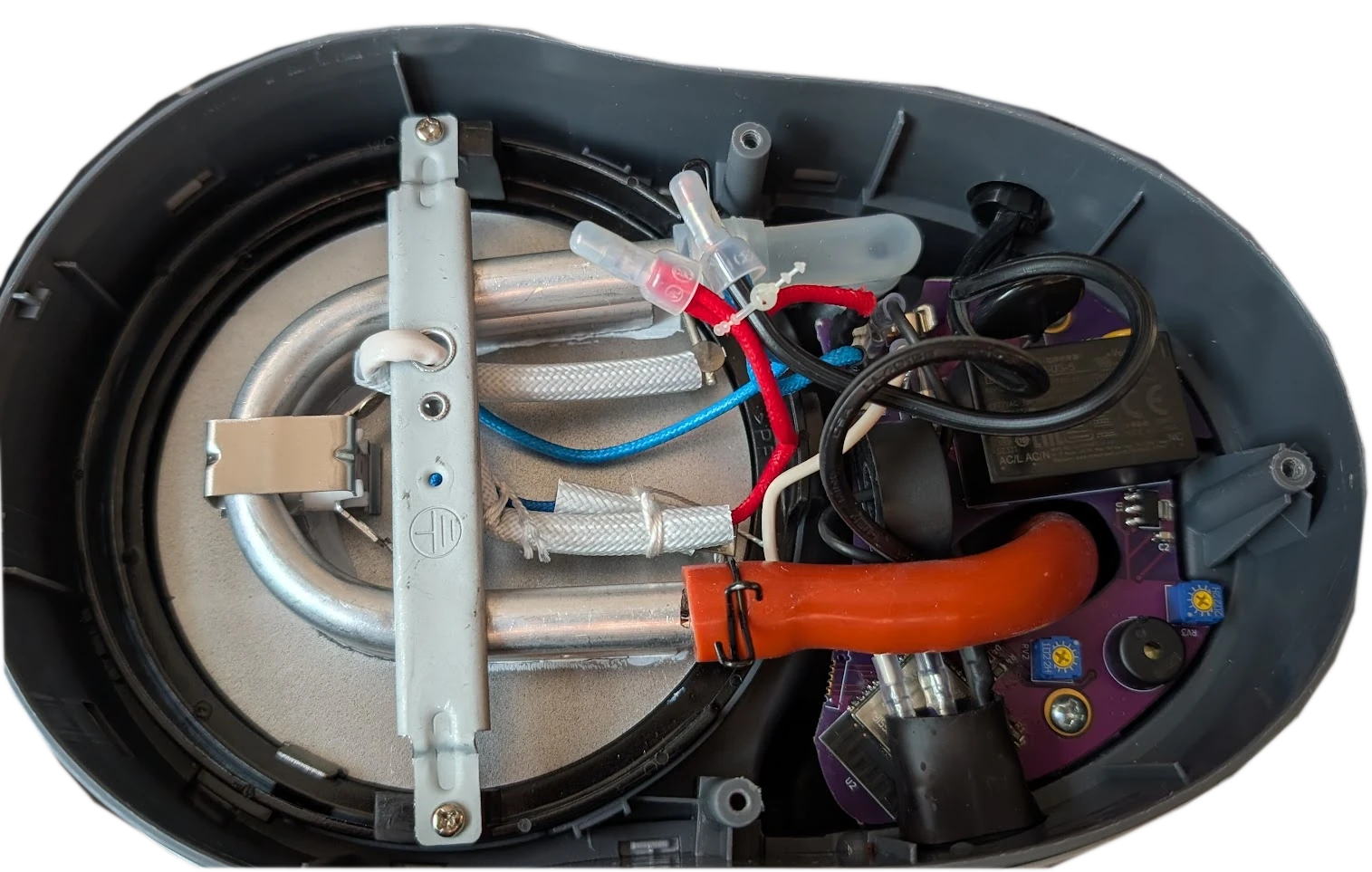 bottom of the coffee maker with a custom board in it